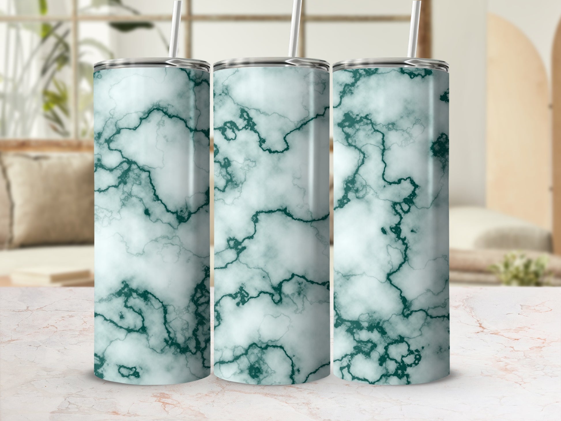 Three tumblers with a green marble pattern and reusable straws.