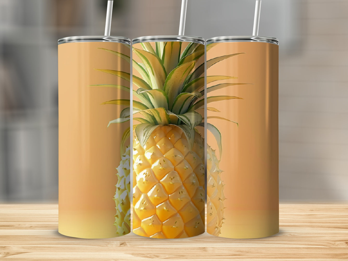Three tumblers with a pineapple design on a wooden surface.