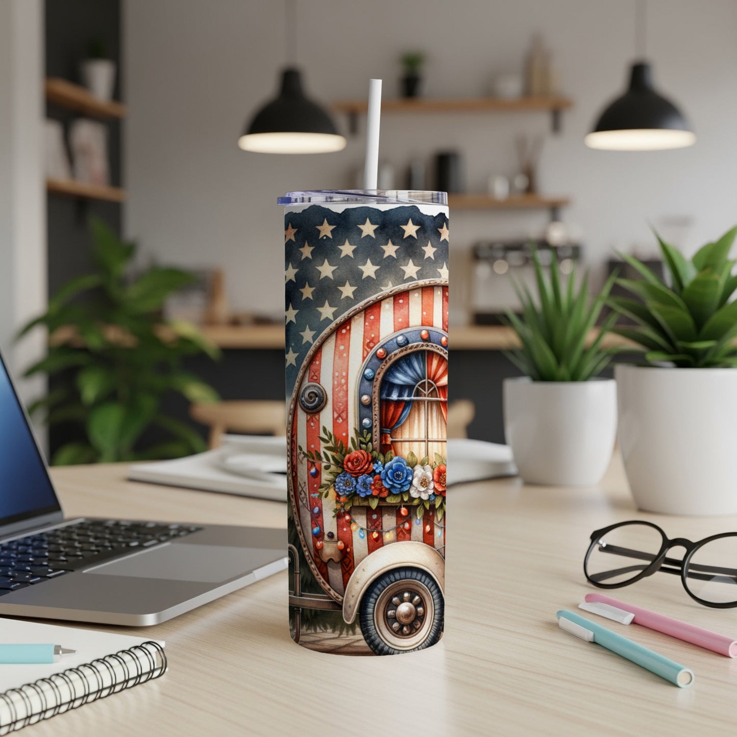 Red, white, and blue patriotic camper tumbler with stars and flowers.