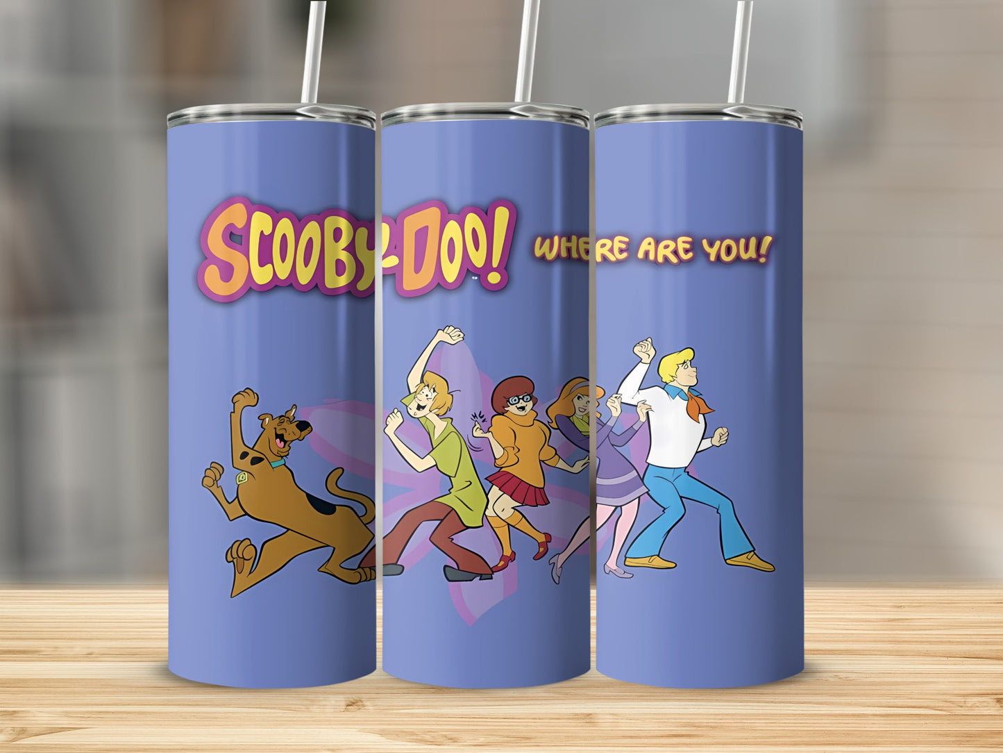 Scooby-Doo characters dancing on a purple tumbler.