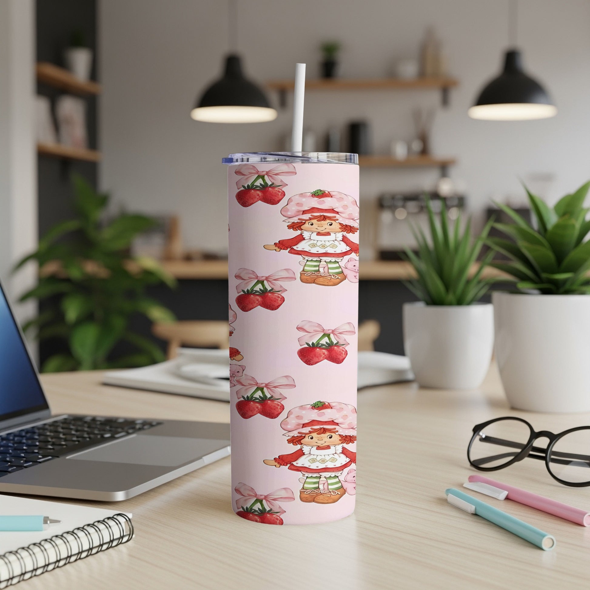 Pink tumbler with repeating pattern of cartoon strawberry girl and cherries.