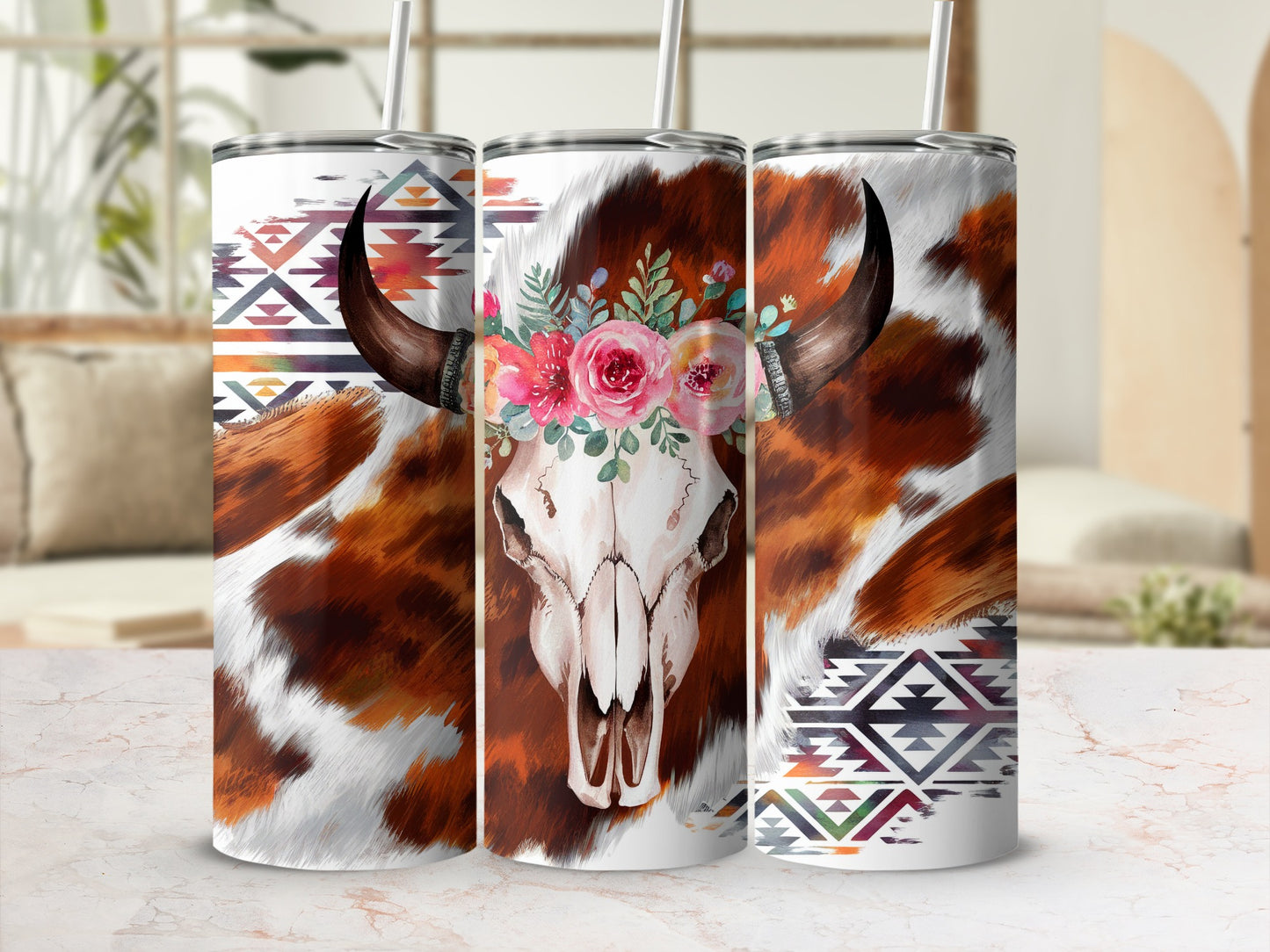 Cow skull with floral crown and southwestern geometric patterns on tumblers.