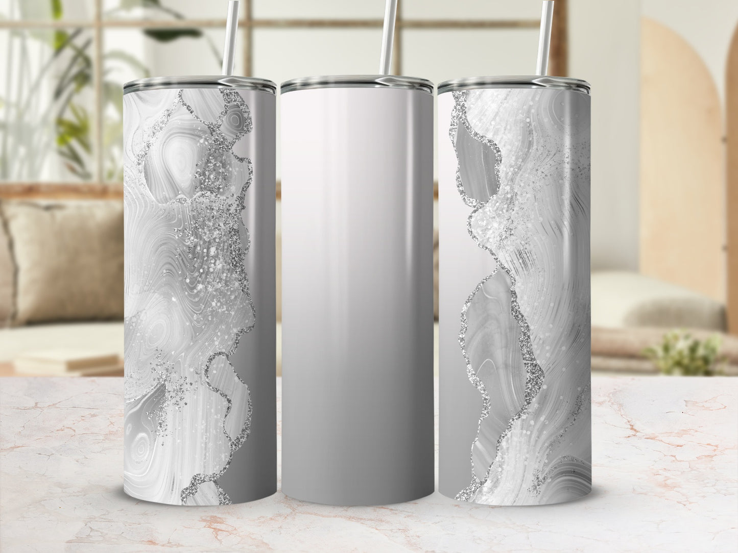 Silver abstract swirl pattern on a white tumbler with a straw.