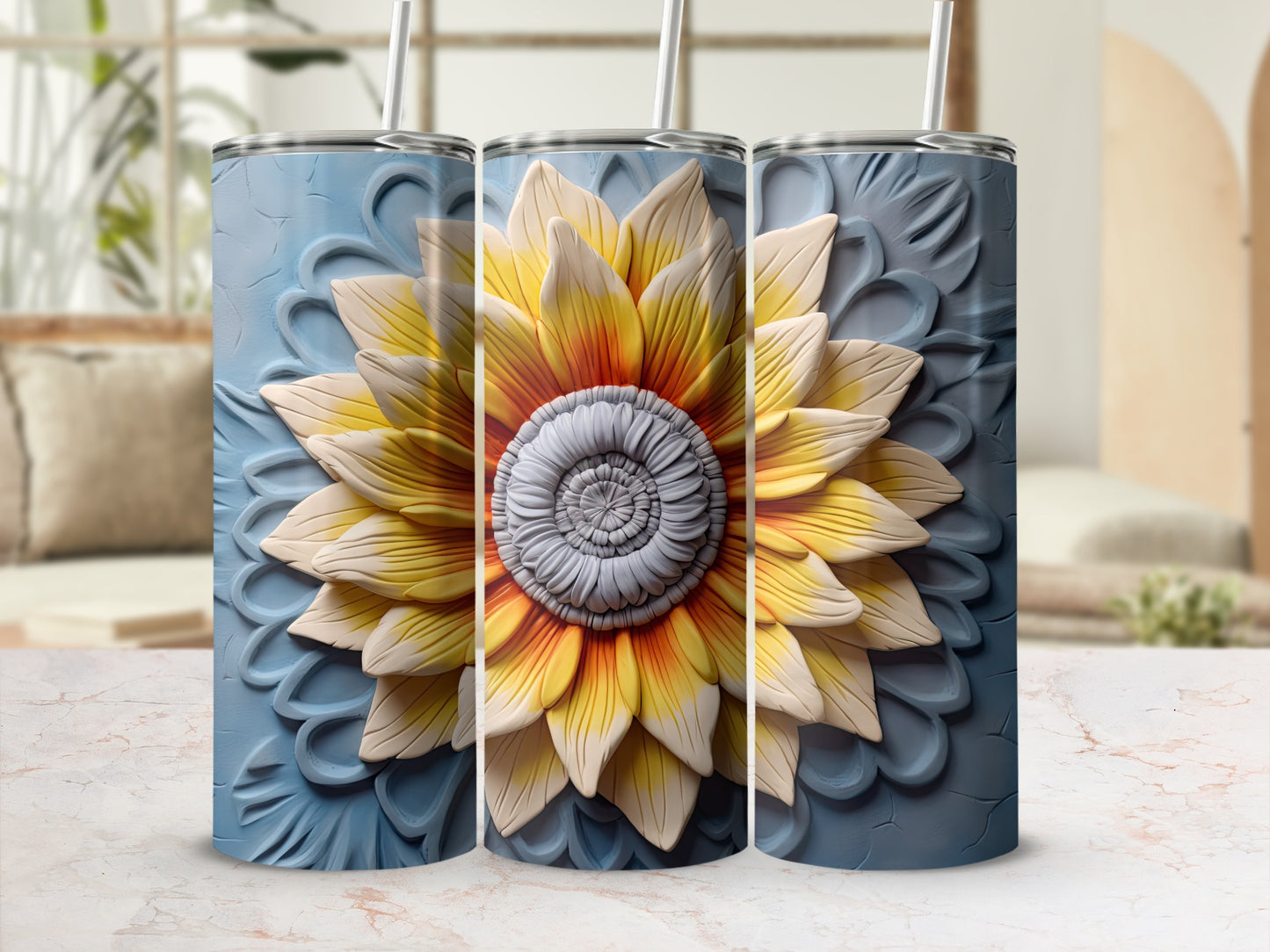 Three blue tumblers with a raised, yellow and orange sunflower design.
