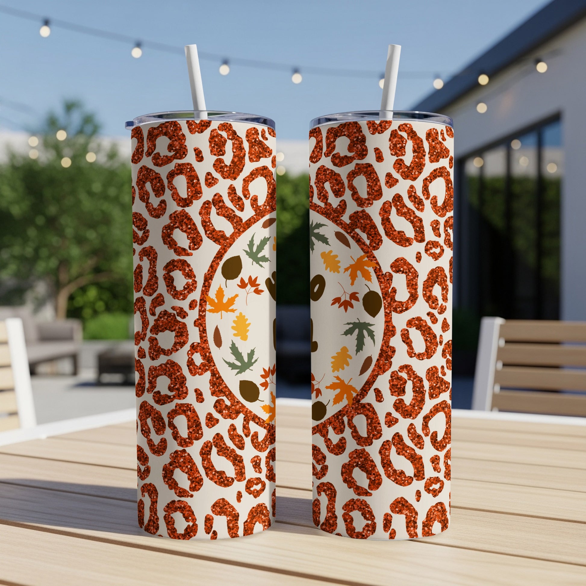 Two tumblers with leopard print and glitter design, featuring fall leaves.