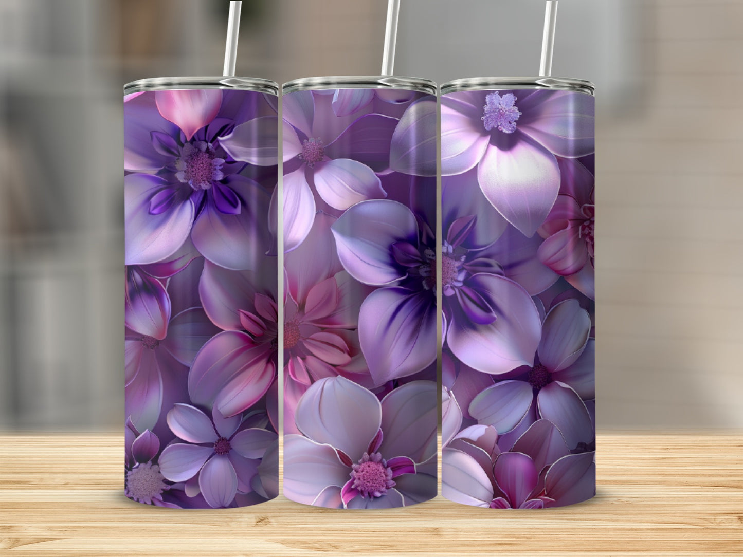 Three tumblers with a purple floral design on a wooden surface.
