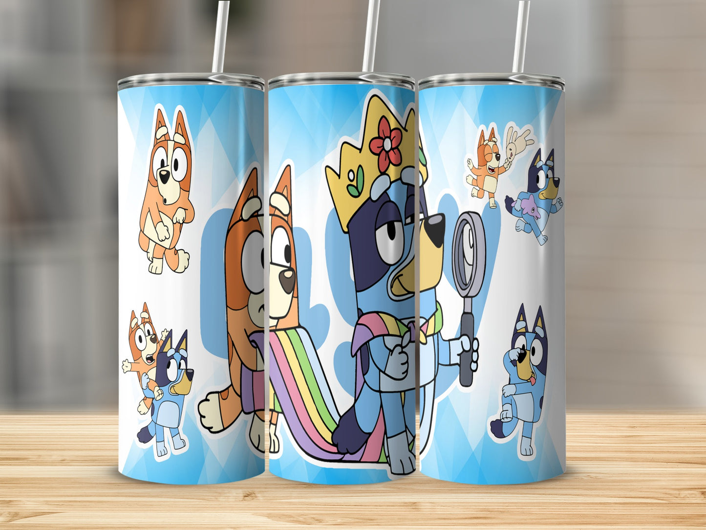 Bluey and Bingo characters on three blue patterned tumblers with straws.