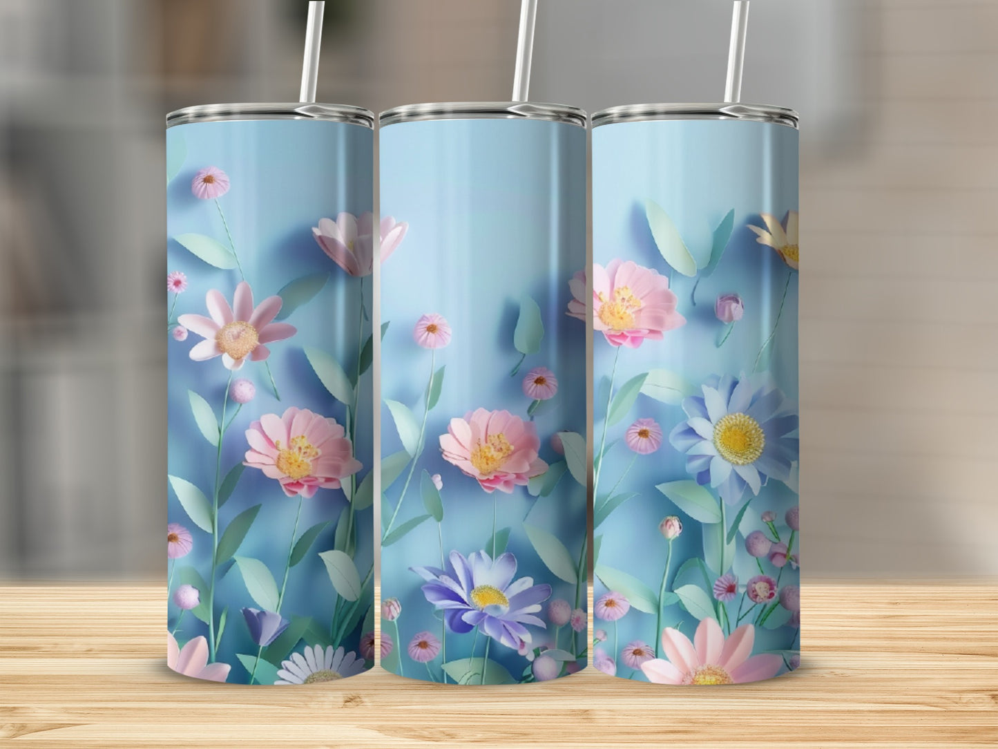 Three blue tumblers with a floral pattern of pink and purple flowers.