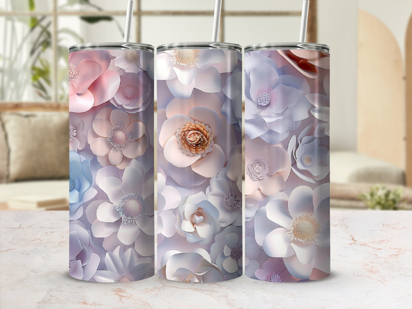 Three tumblers with delicate pastel floral designs and straws.