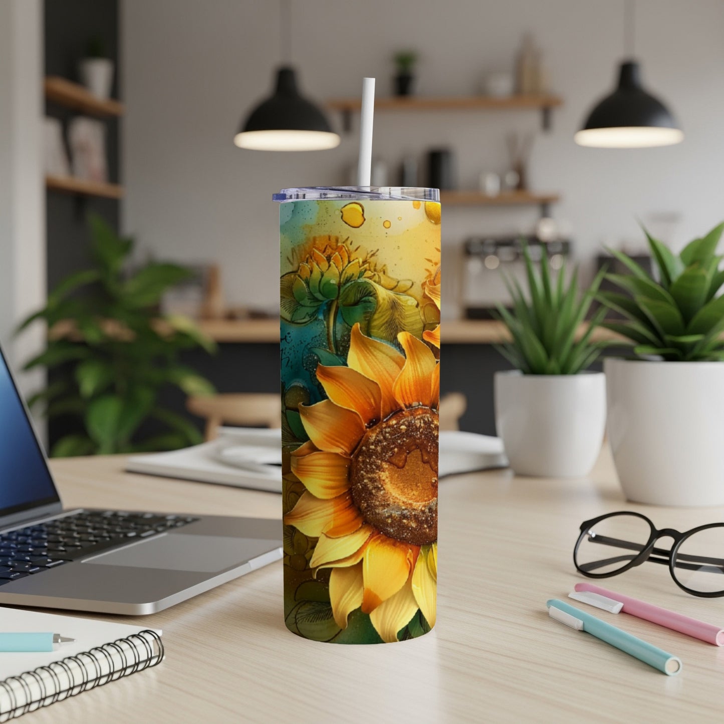 Tall tumbler with a large sunflower design on a desk.