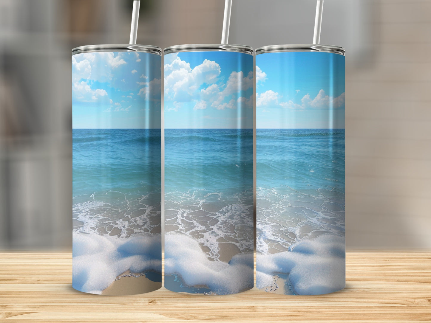 Three tumblers featuring a beach scene with ocean waves and clouds.