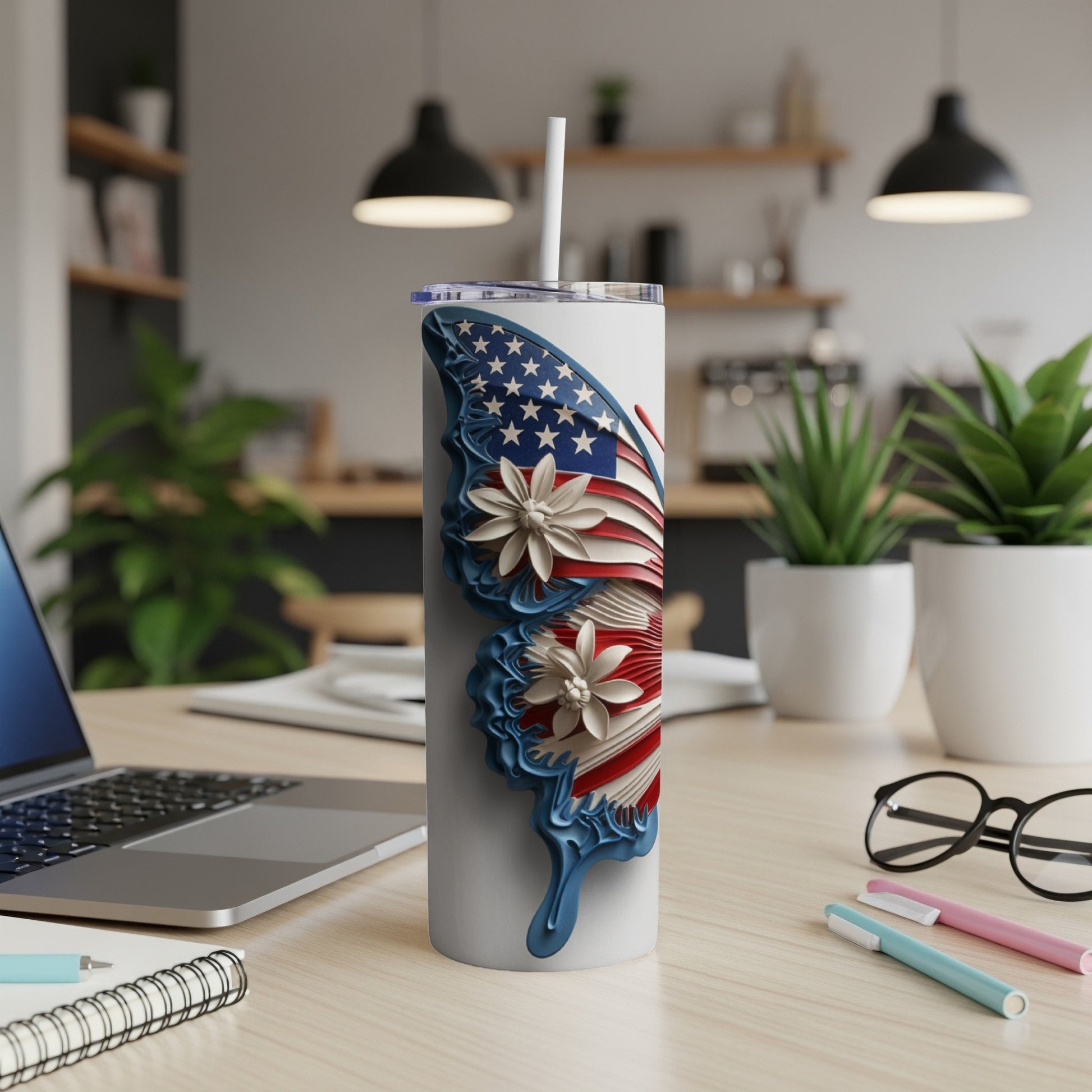 White tumbler with an American flag butterfly design and white flowers.