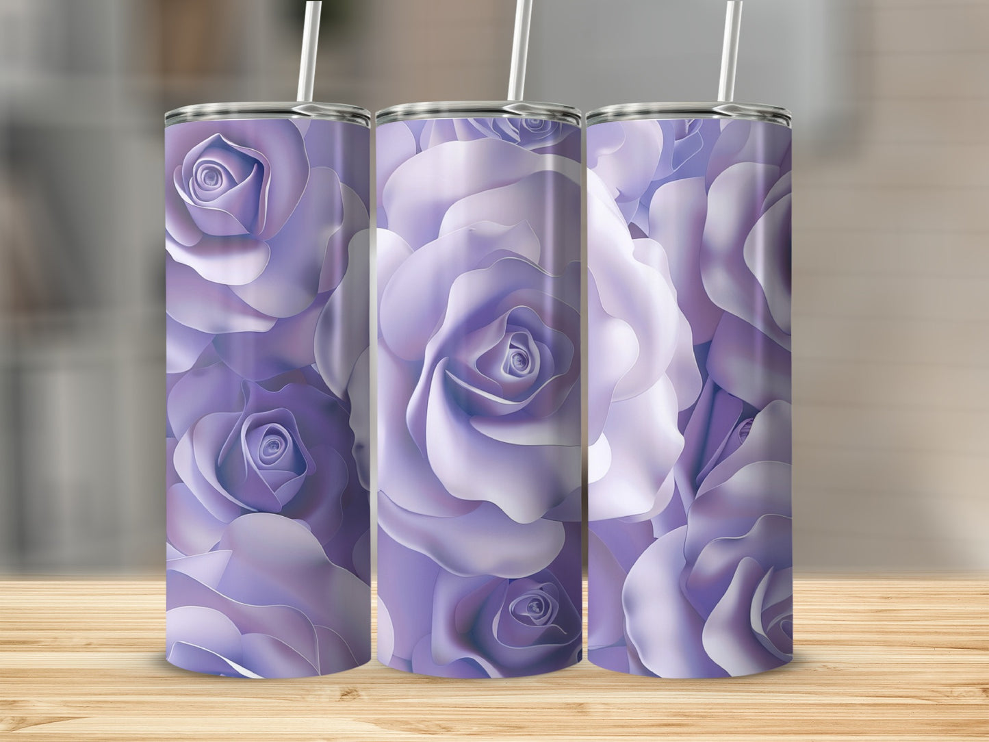 Three purple rose patterned tumblers with straws on a wooden surface.