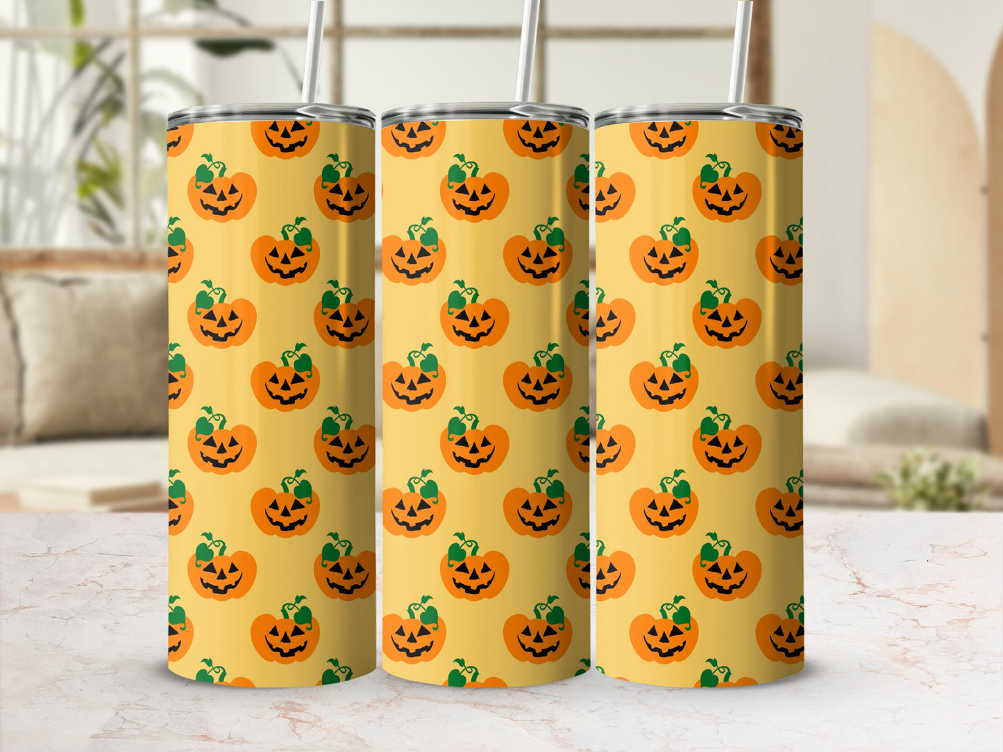 Three tumblers with a repeating pattern of jack-o'-lanterns on a yellow background.