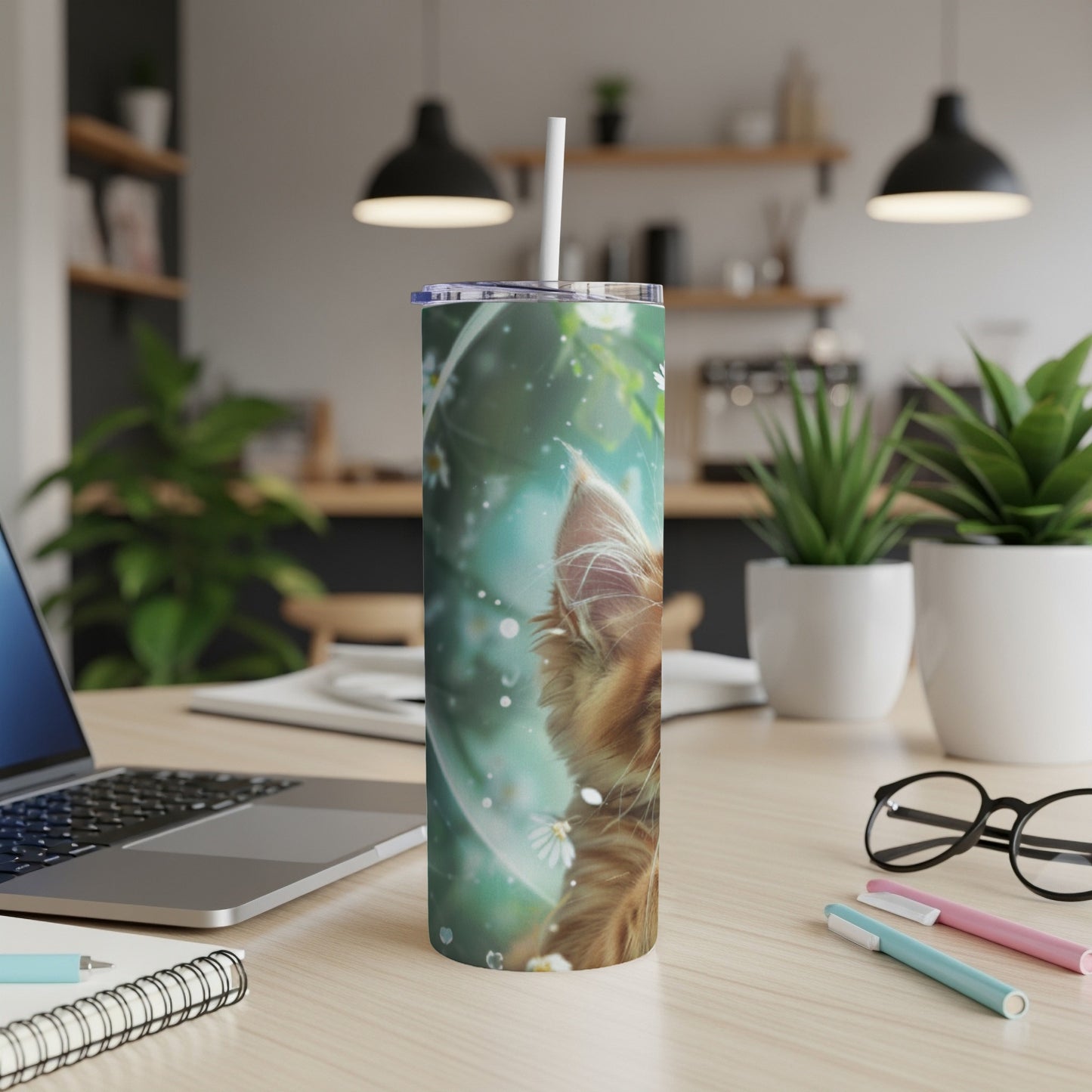 Orange cat's face peeking through bubble with floral accents on a tumbler.
