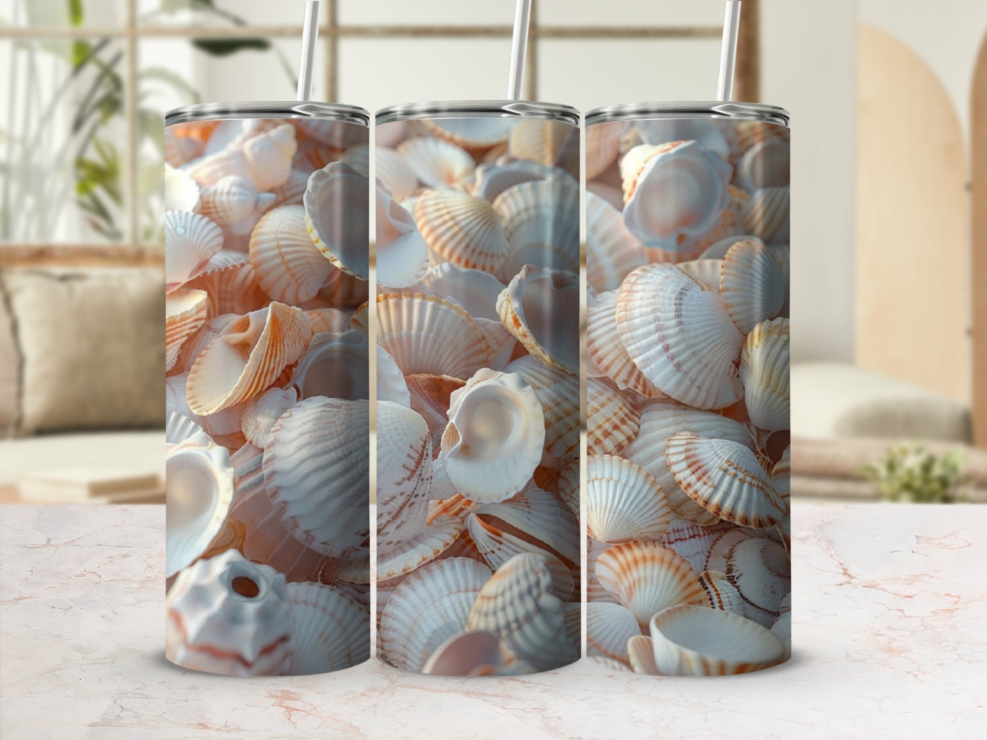 Three tumblers with a close-up pattern of seashells on a marble surface.