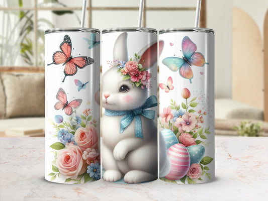Bunny with flowers and butterflies on a tumbler with Easter eggs.