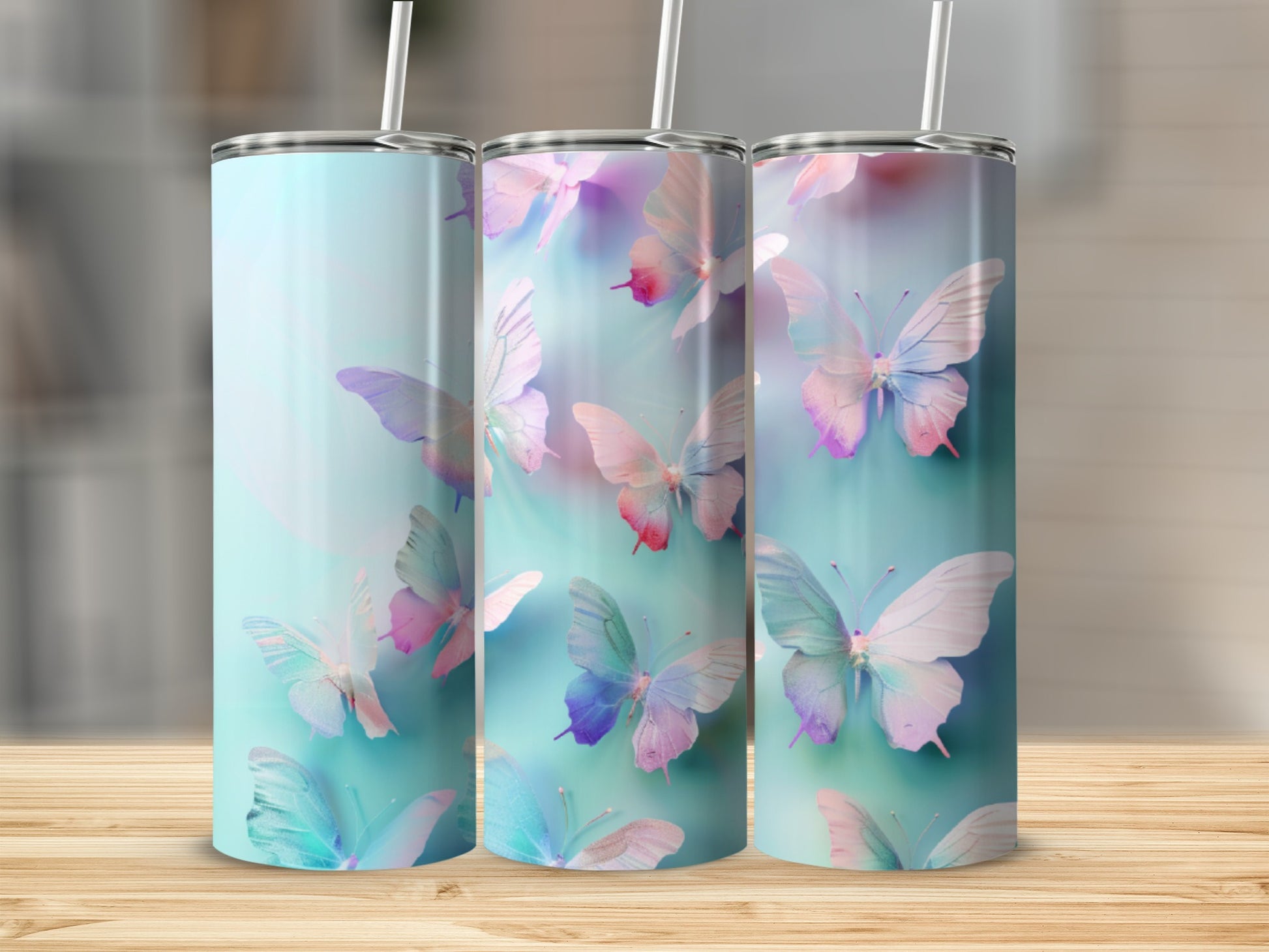 Three tumblers with pastel butterflies against a gradient background.