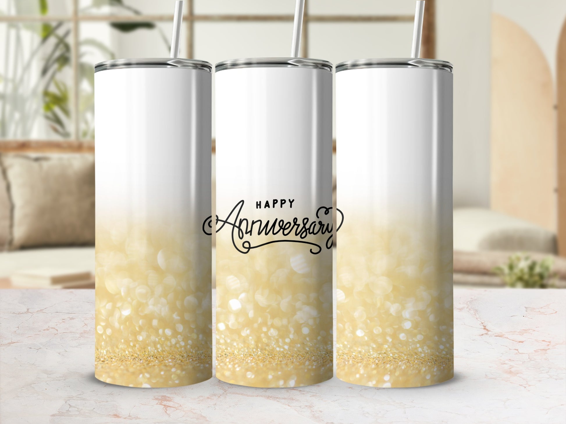 "Happy Anniversary" text on a gold glitter tumbler with a straw.