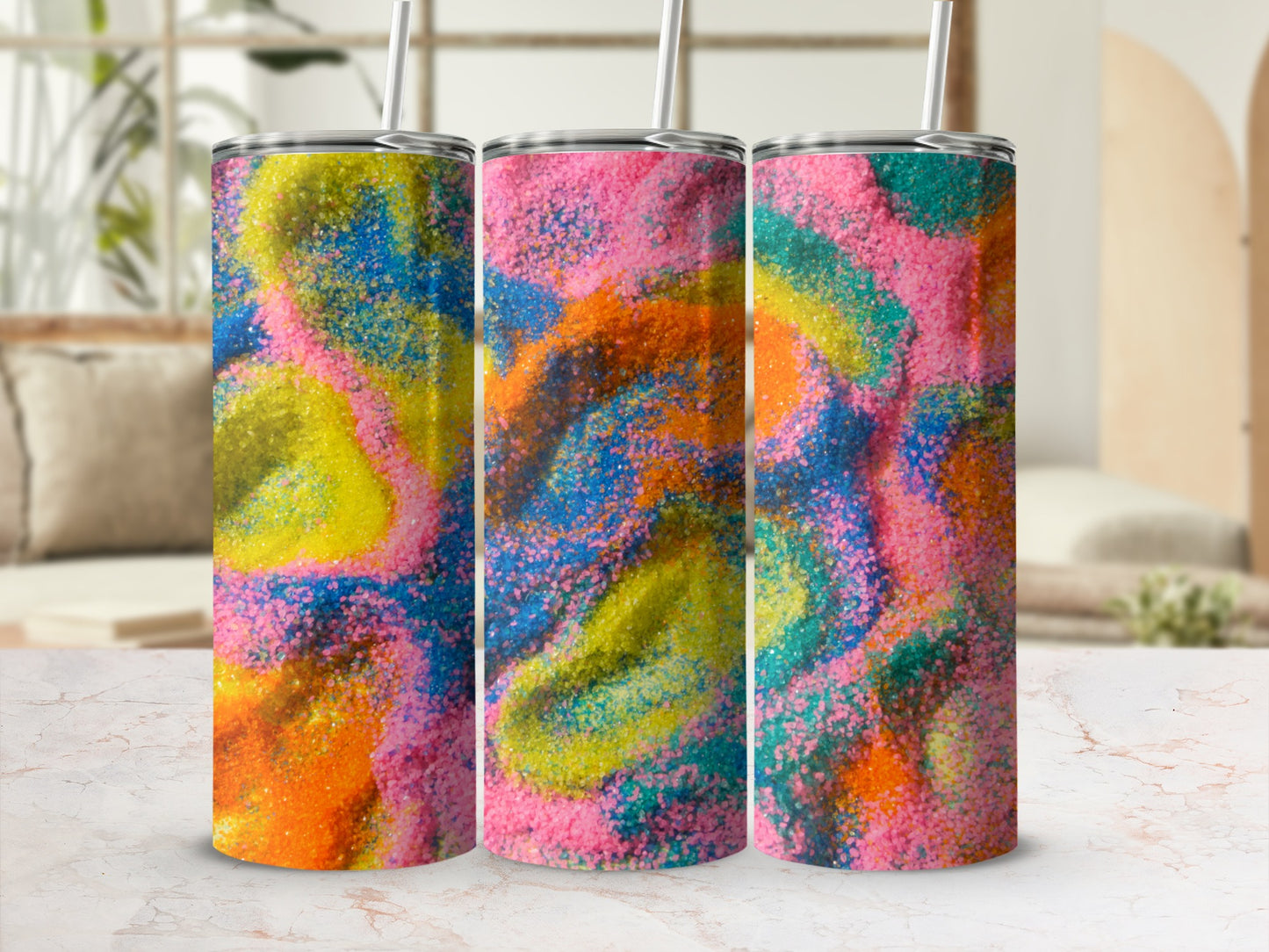 Three tumblers with colorful abstract sand art design.
