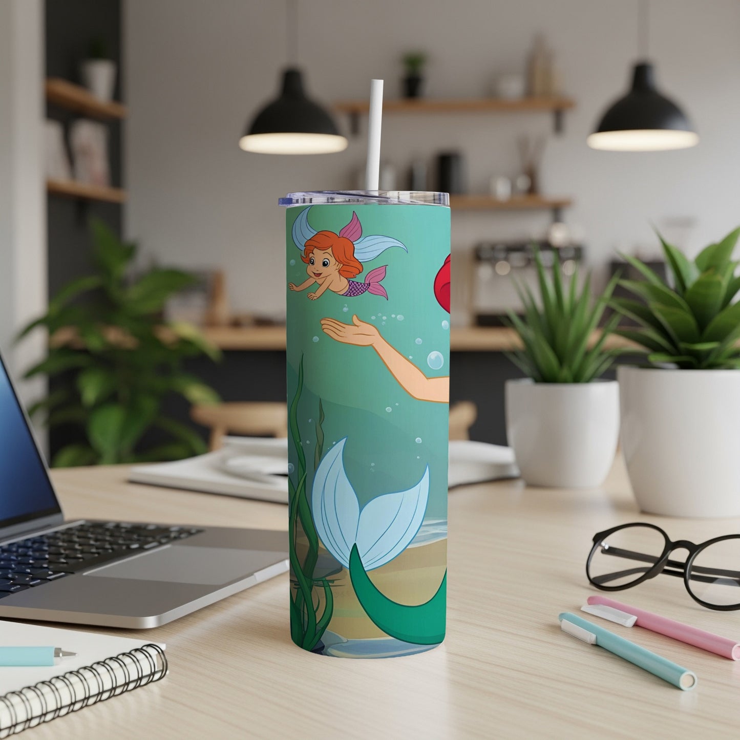 Ariel reaching for bubbles on a mermaid-themed tumbler.