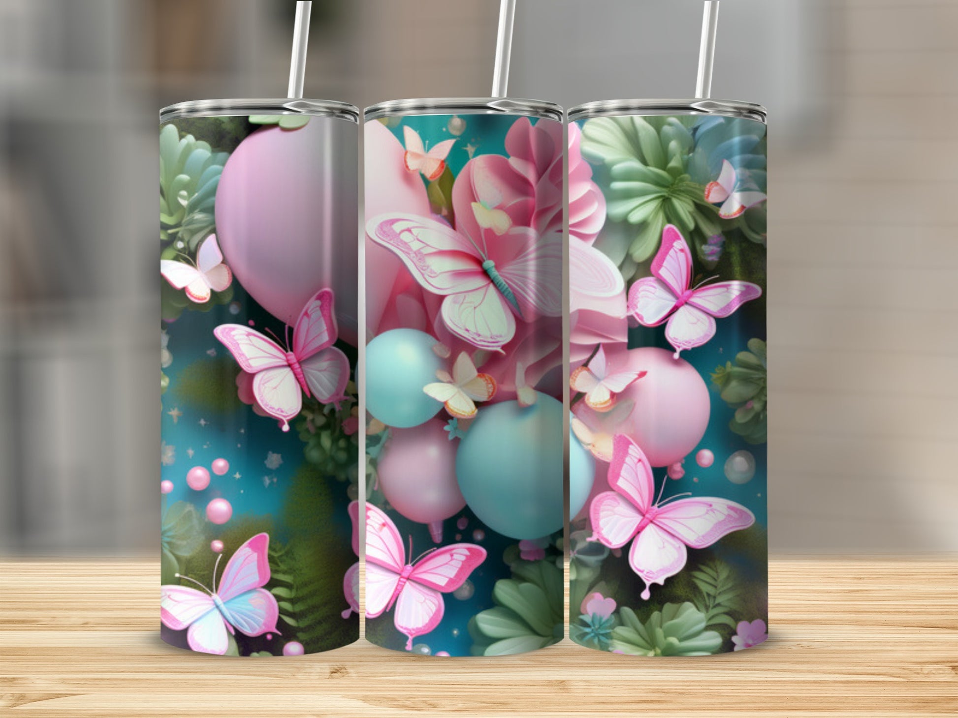 Three pink, teal, and pastel floral patterned tumblers with butterflies.