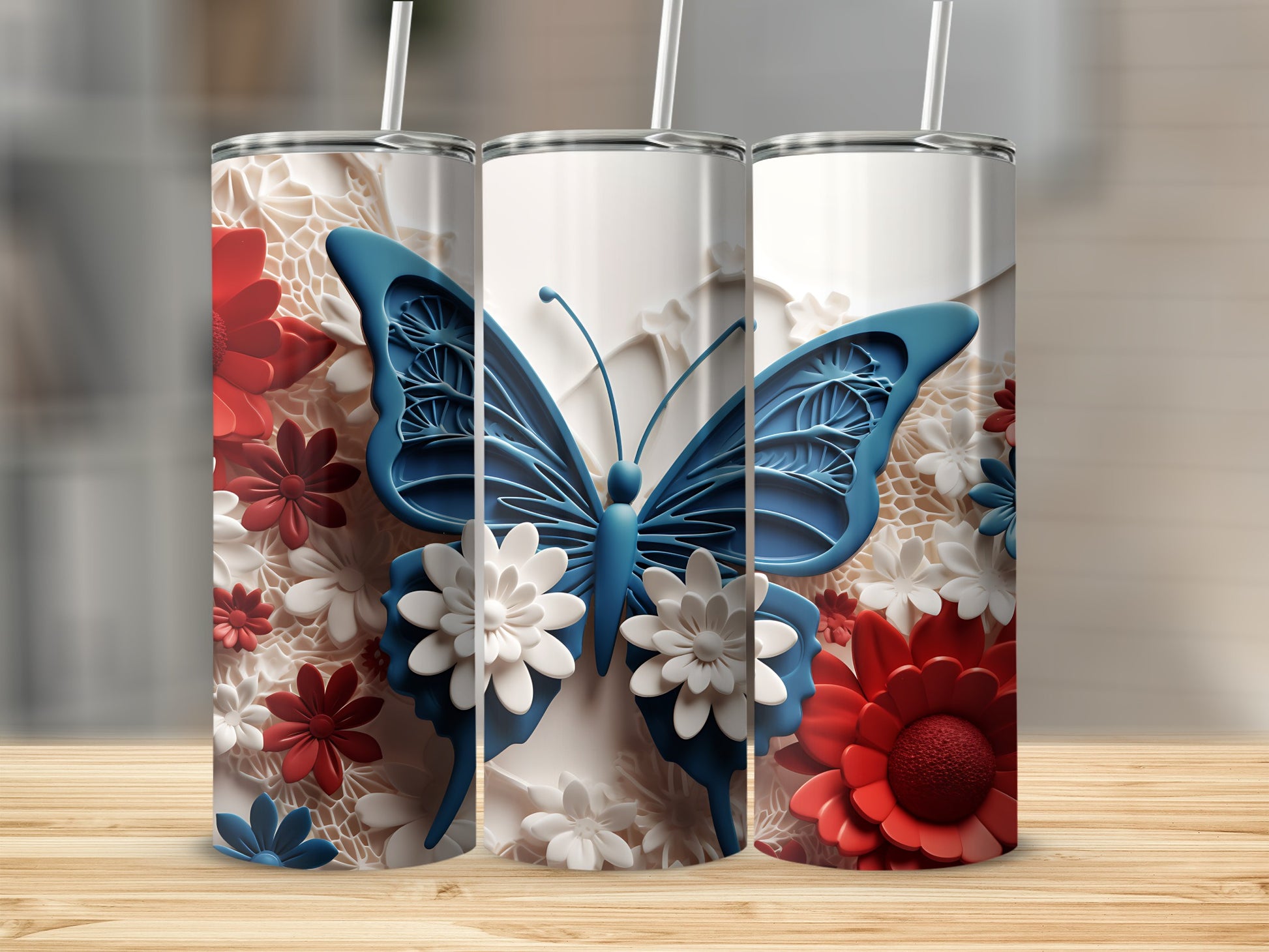 Three white tumblers with red and white floral patterns and blue butterfly designs.