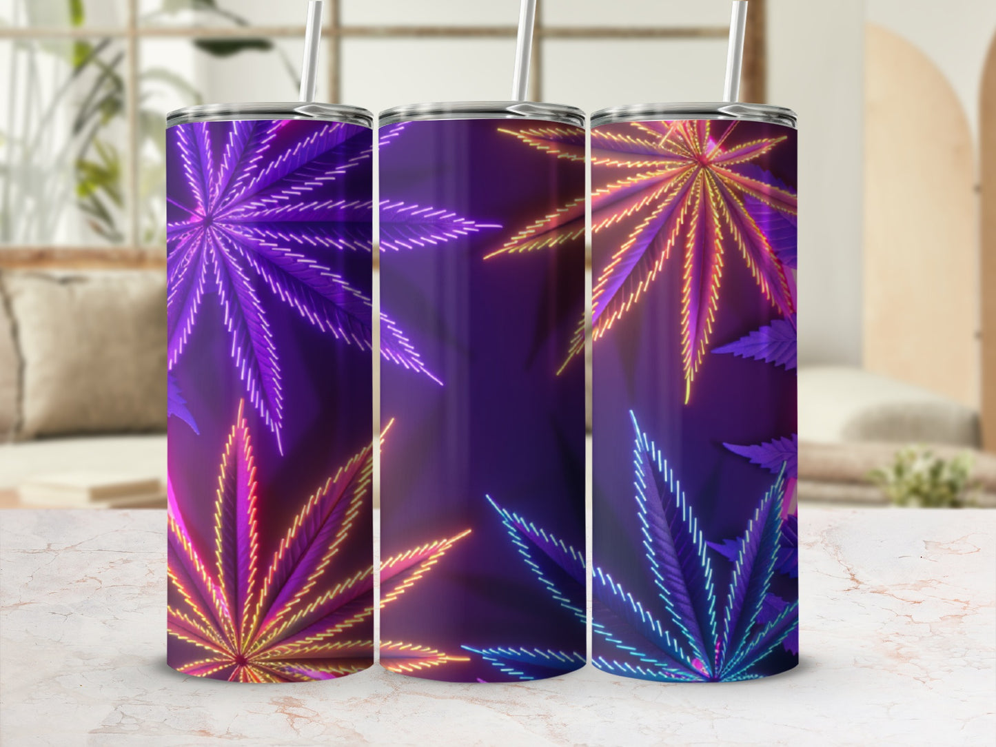 Three glowing cannabis leaf pattern tumblers with straws on a marble surface.