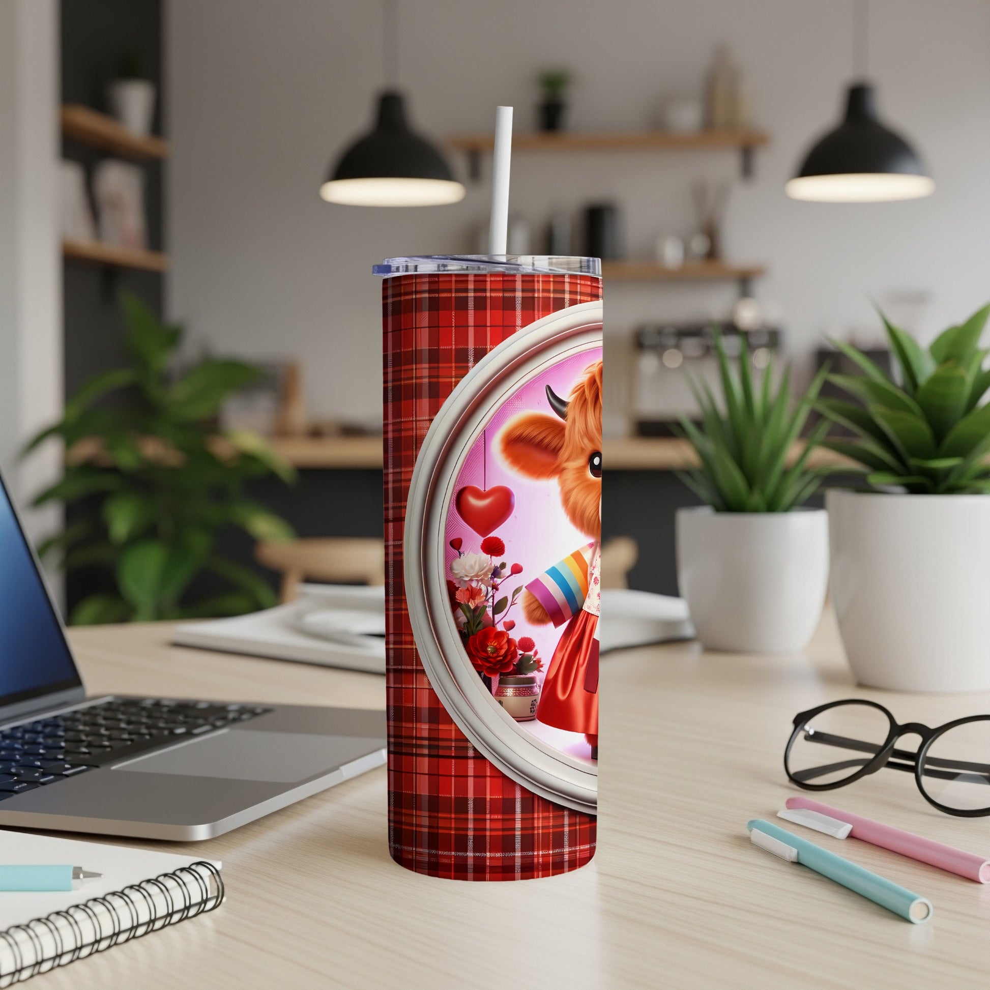 Red plaid tumbler with a cartoon cow character wearing a rainbow stripe shirt.