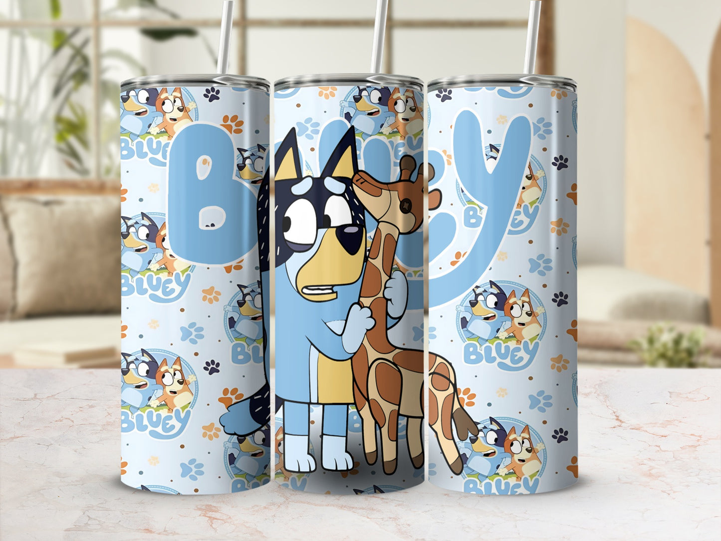 Bluey and Bingo characters on a light blue tumbler with giraffe pattern.