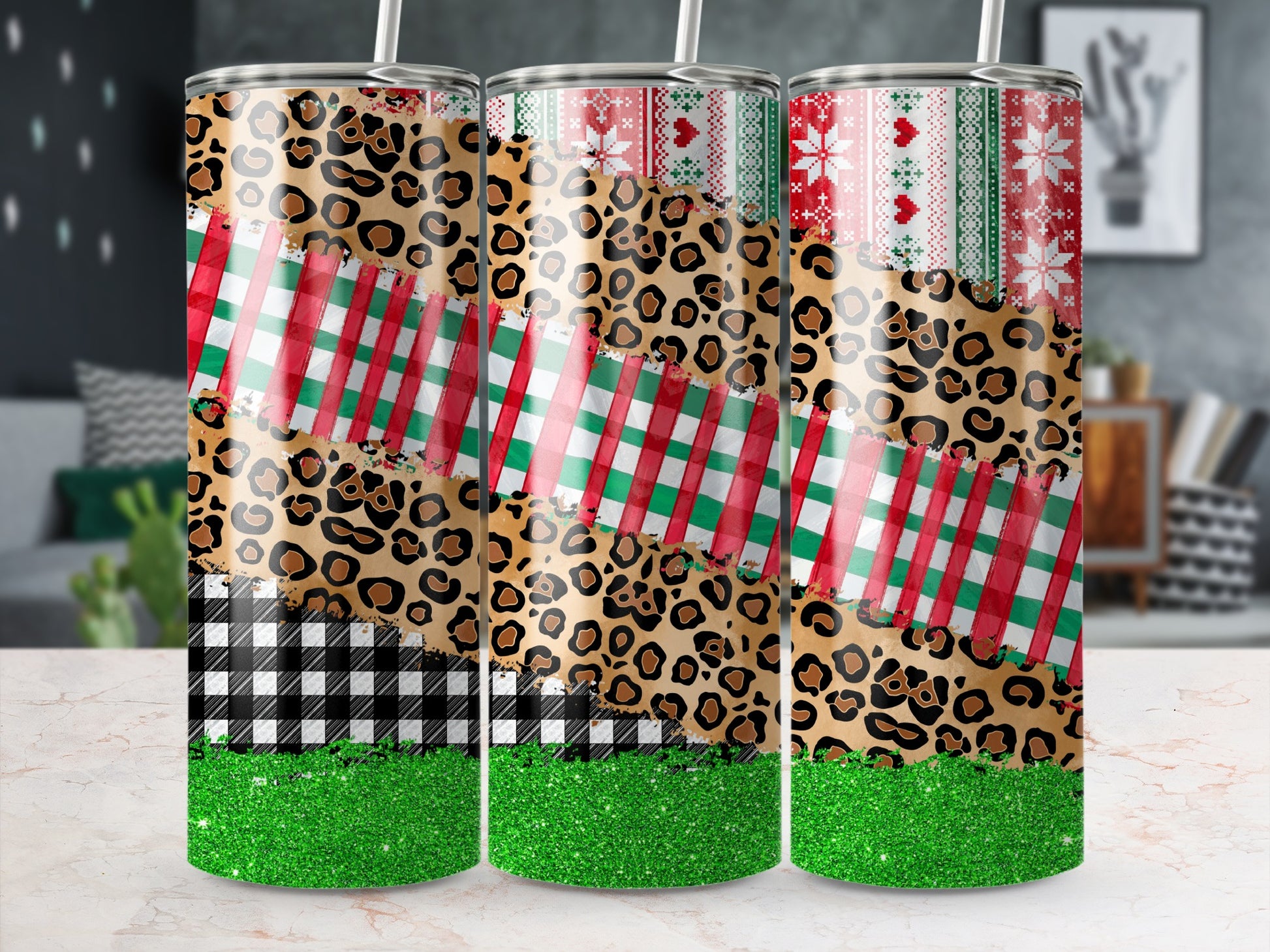 Three tumblers with leopard, plaid, and snowflake patterns and green glitter bottoms.