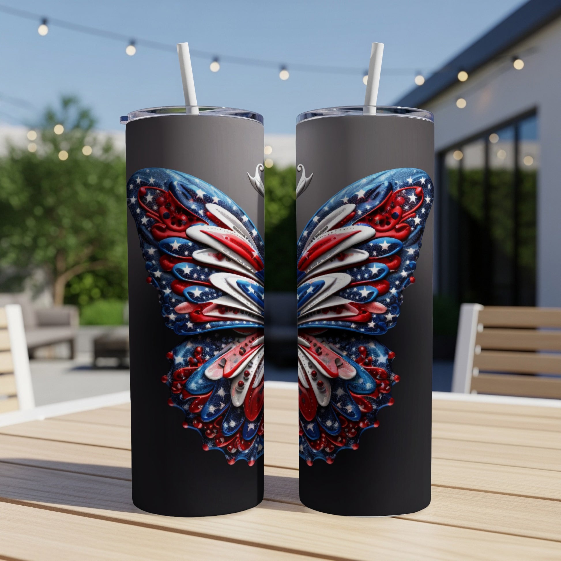 Two tumblers with a patriotic butterfly wing design on a patio table.