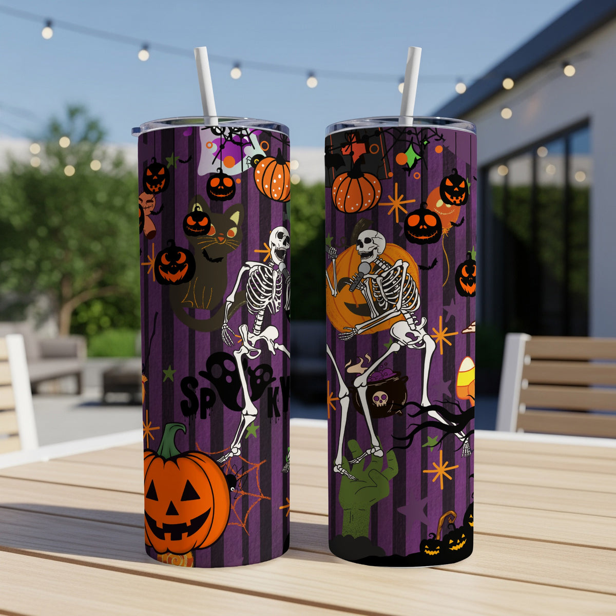 Two Halloween-themed tumblers with skeletons, pumpkins, and a black cat.