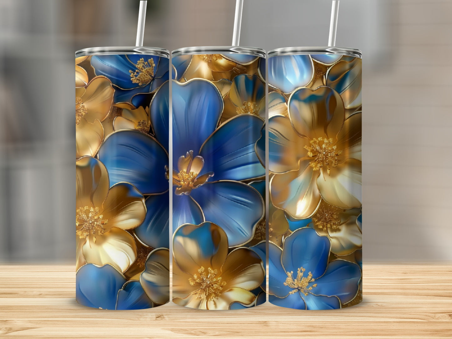 Blue and gold floral pattern on three tumblers with straws.