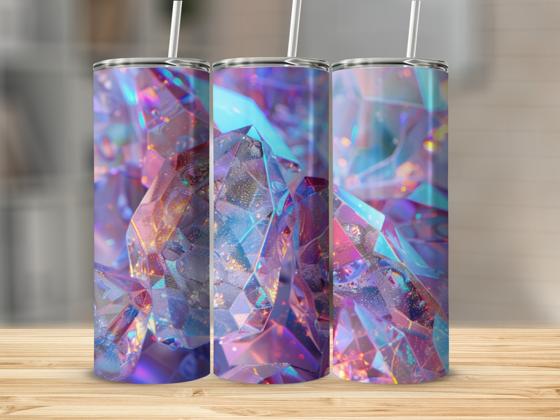 Three tumblers with iridescent, faceted gem-like designs on a wooden surface.