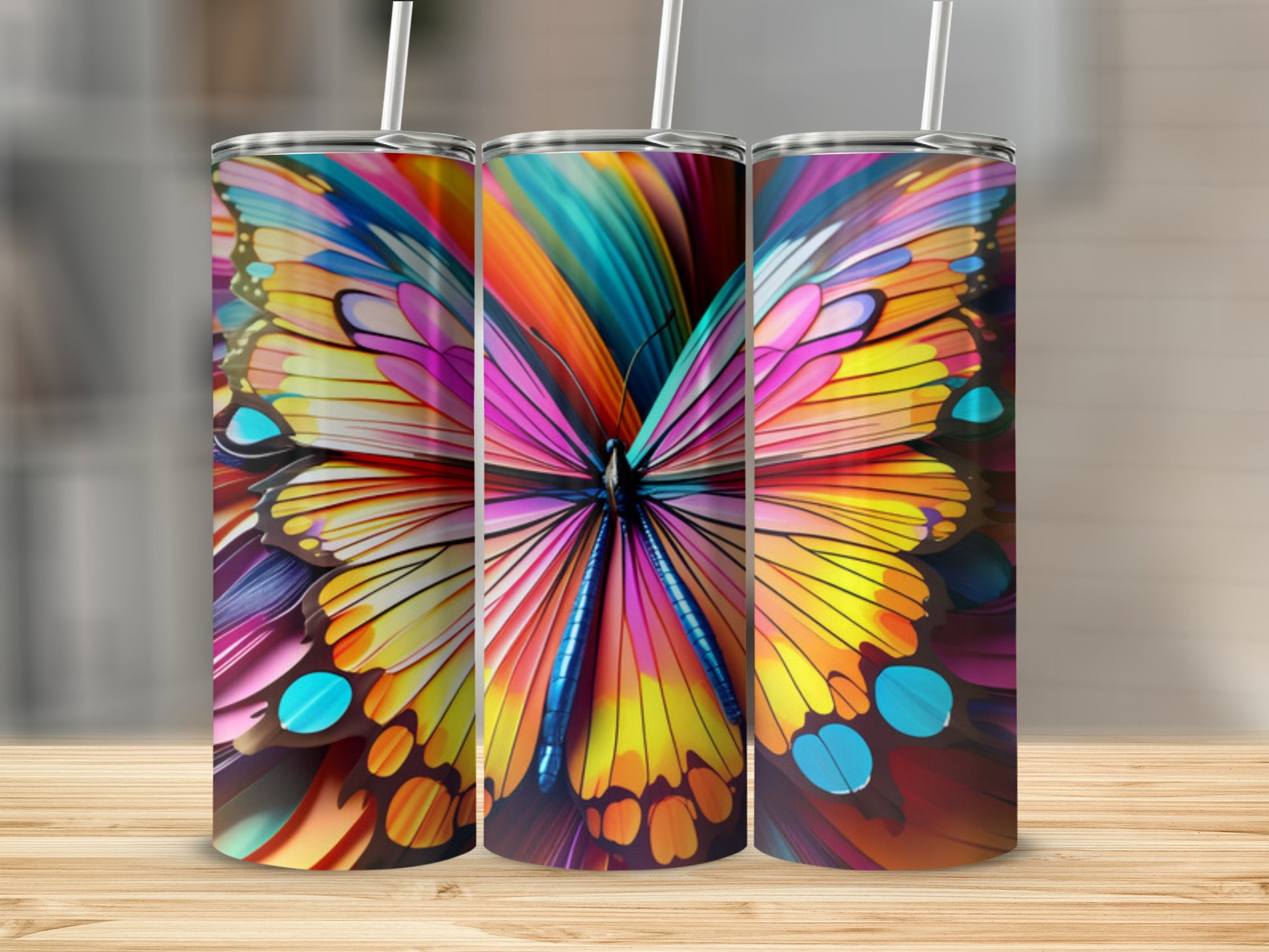 Three colorful tumblers feature a vibrant butterfly wing design.