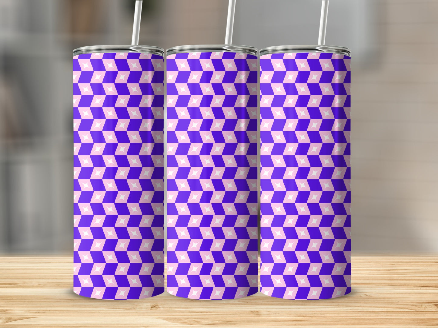 Three tumblers with a purple and pink geometric pattern stand on a wooden surface.