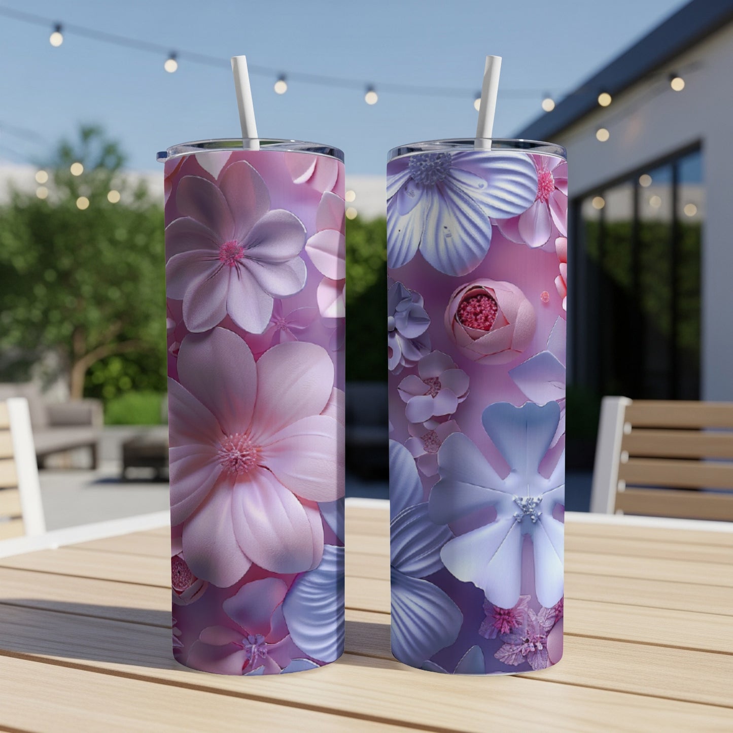 Two tall tumblers with floral designs stand on a table.