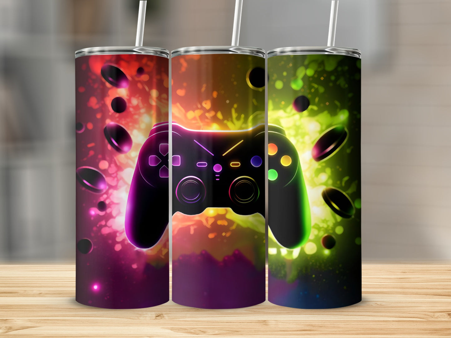 Three tumblers decorated with a glowing video game controller and colorful abstract background.