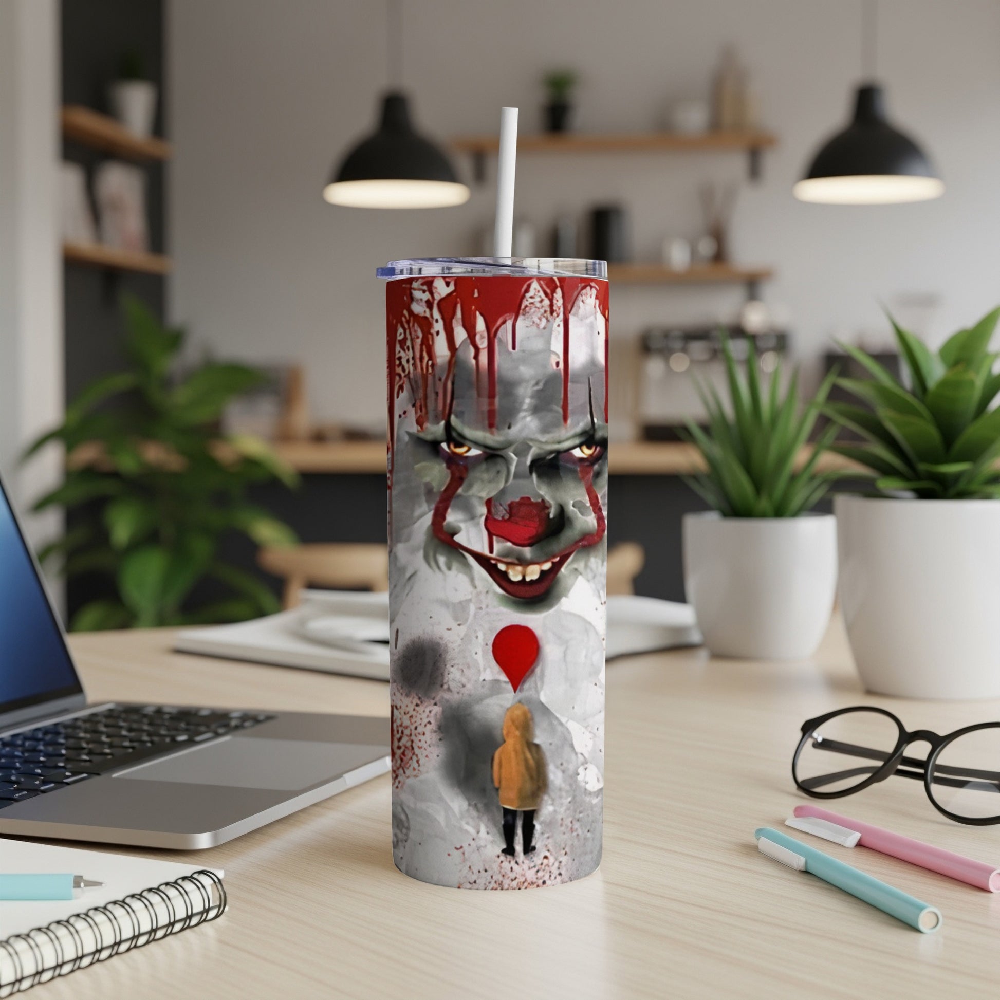 Creepy clown face on tumbler with a child holding a red balloon.