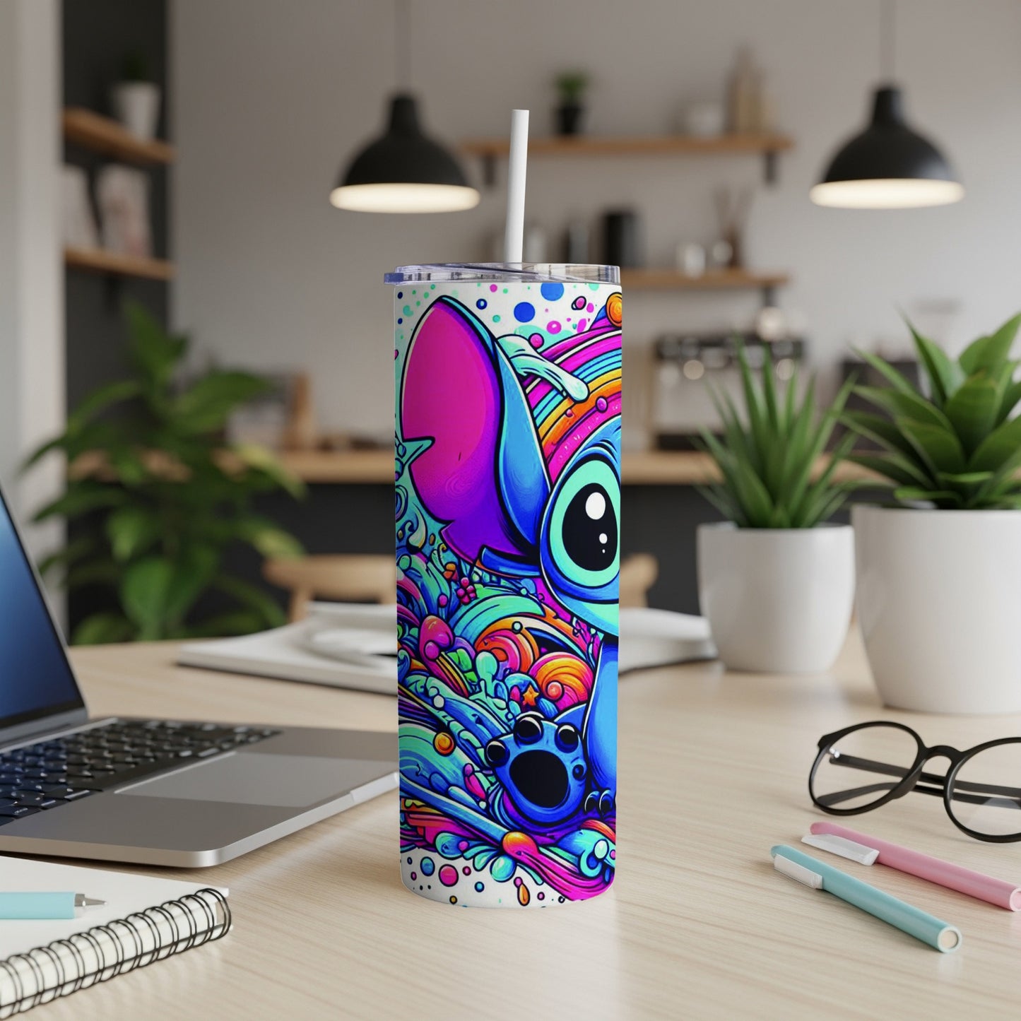 Stitch character on a colorful, abstract patterned skinny tumbler with white straw.