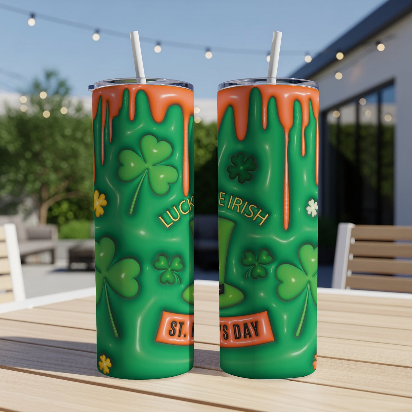 Two green tumblers with shamrock and dripping orange slime designs for St. Patrick's Day.