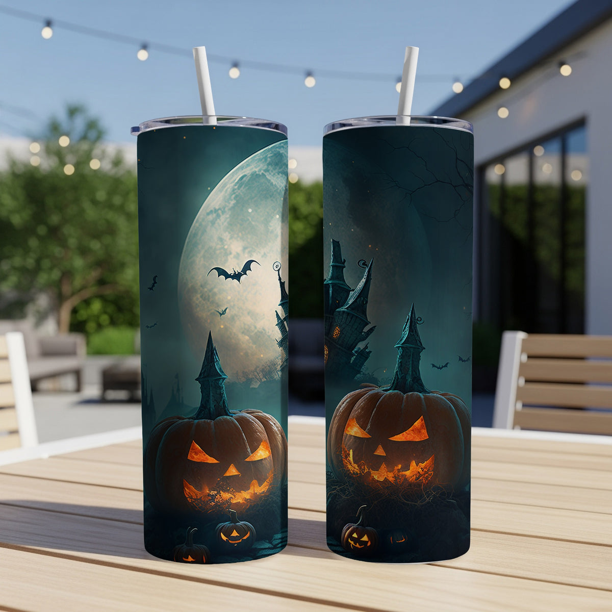 Two Halloween tumblers with jack-o'-lanterns and a spooky castle under a full moon.