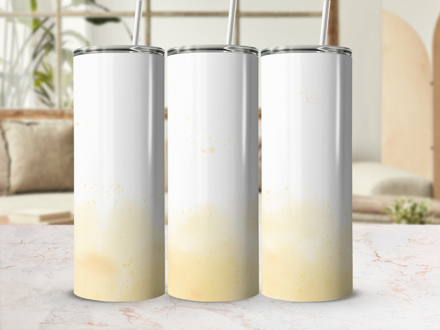 Three white tumblers with yellow paint splatter design.