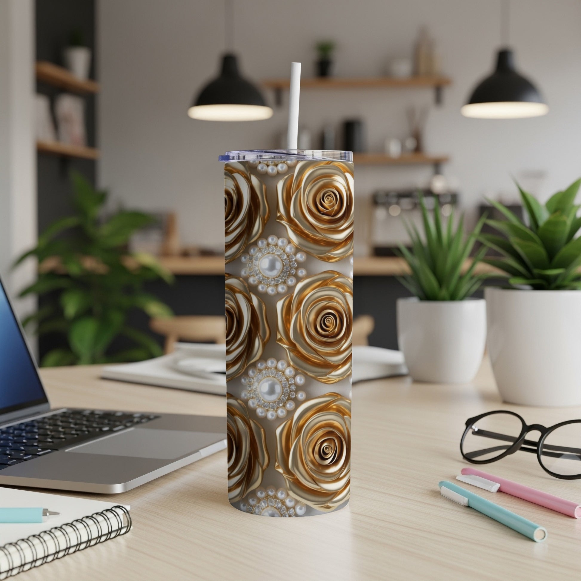 Gold roses with pearl accents wrap a stainless steel tumbler with a straw.