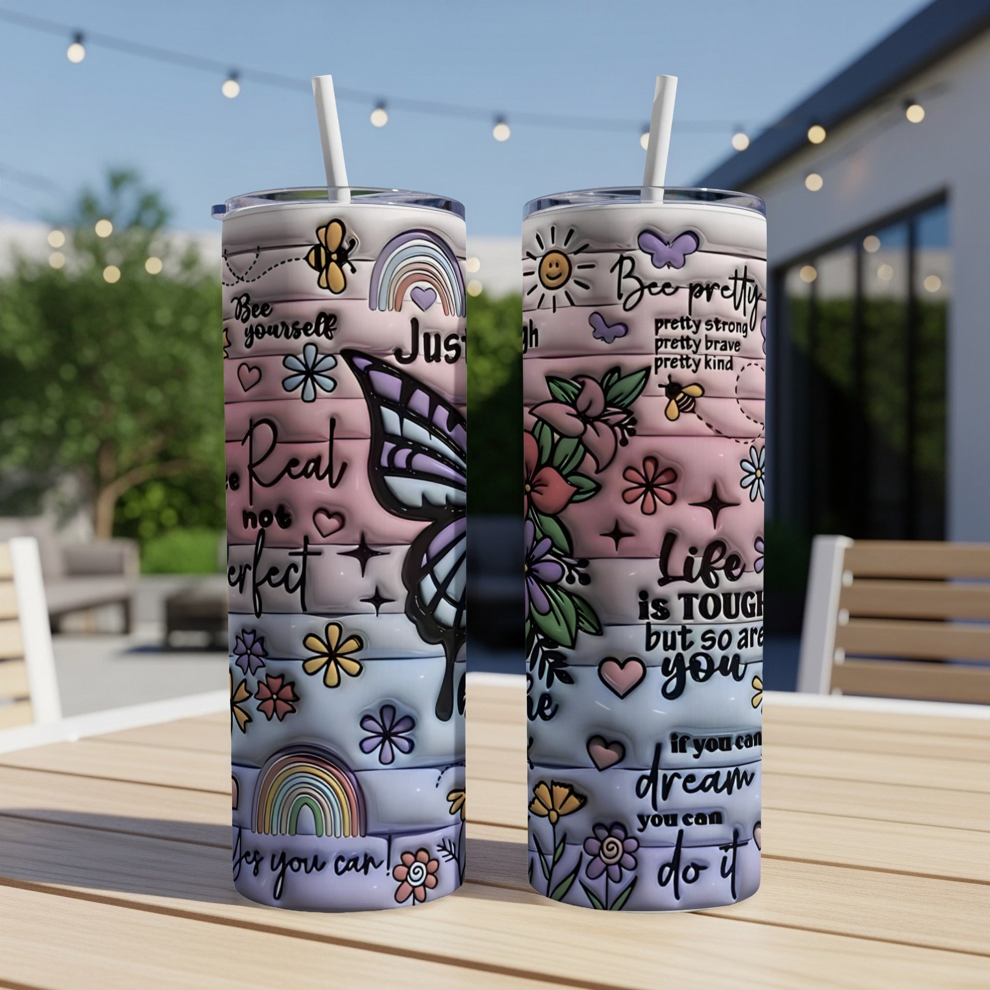 Tumbler with butterfly, rainbow, floral designs, and inspirational text.