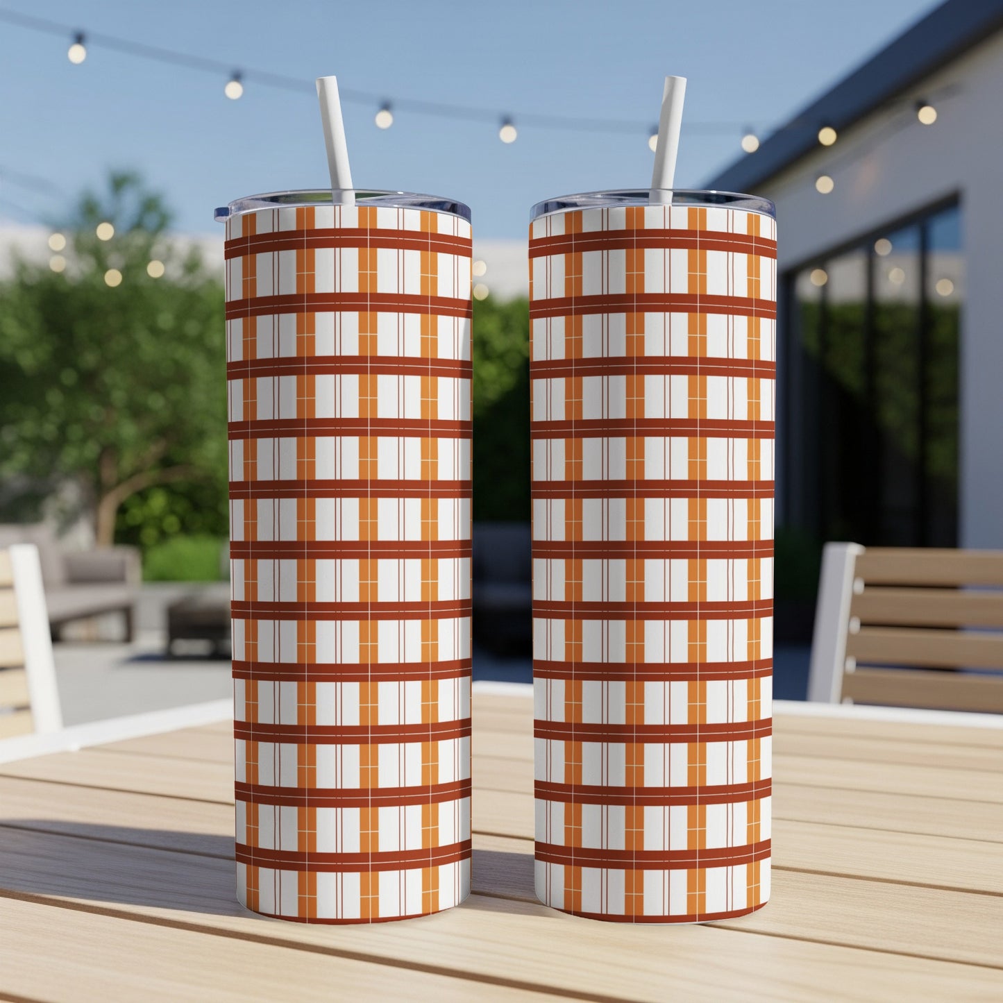 Two tall tumblers with orange and white plaid pattern, each with a straw.