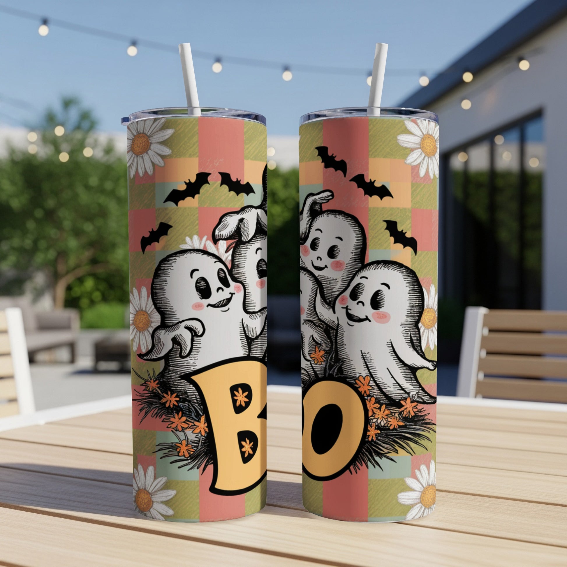 Two tumblers with Halloween ghosts, bats, daisies, and the word "BOO" on plaid.
