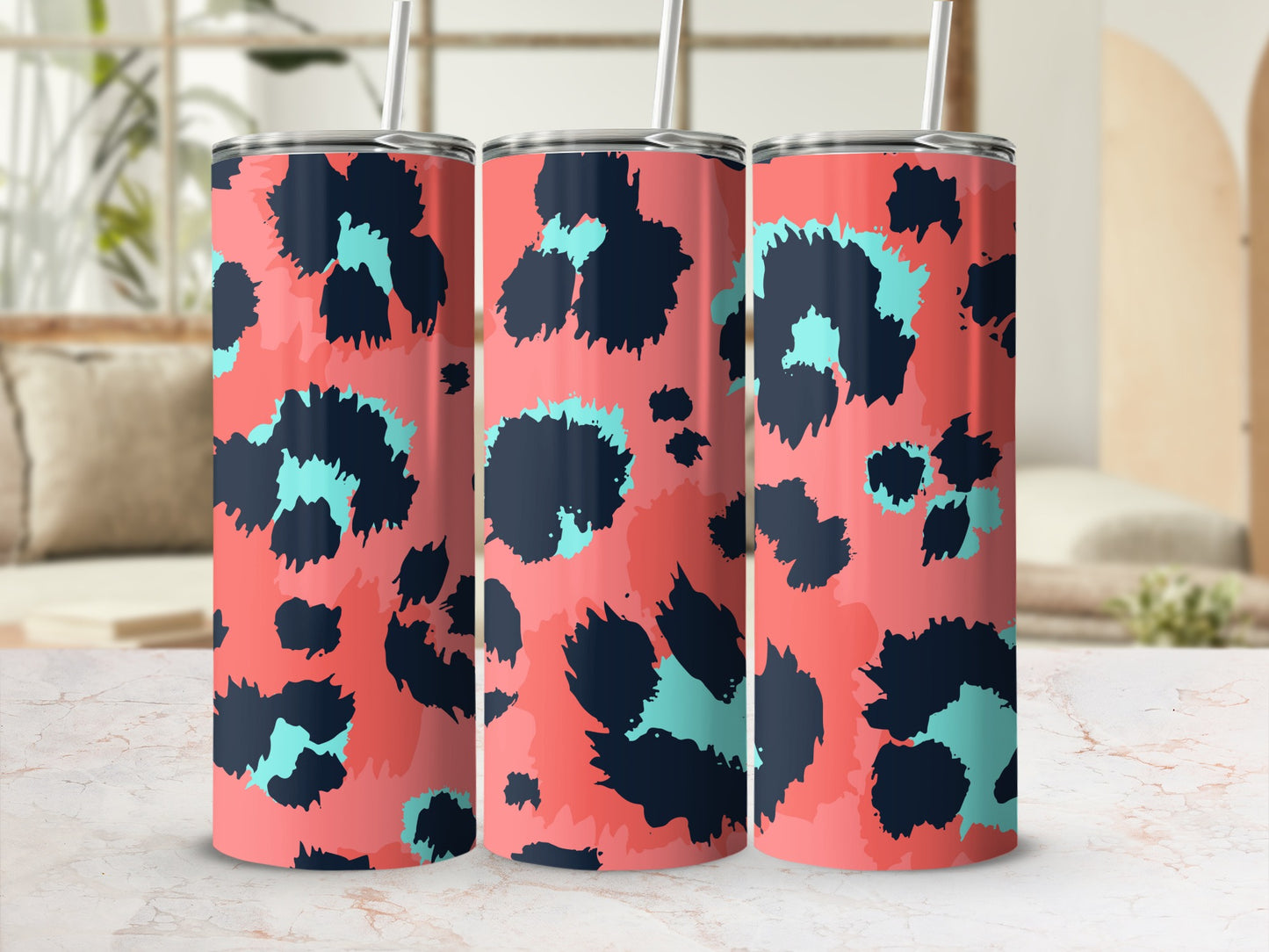 Three tumblers with a coral background and black and turquoise abstract leopard print.