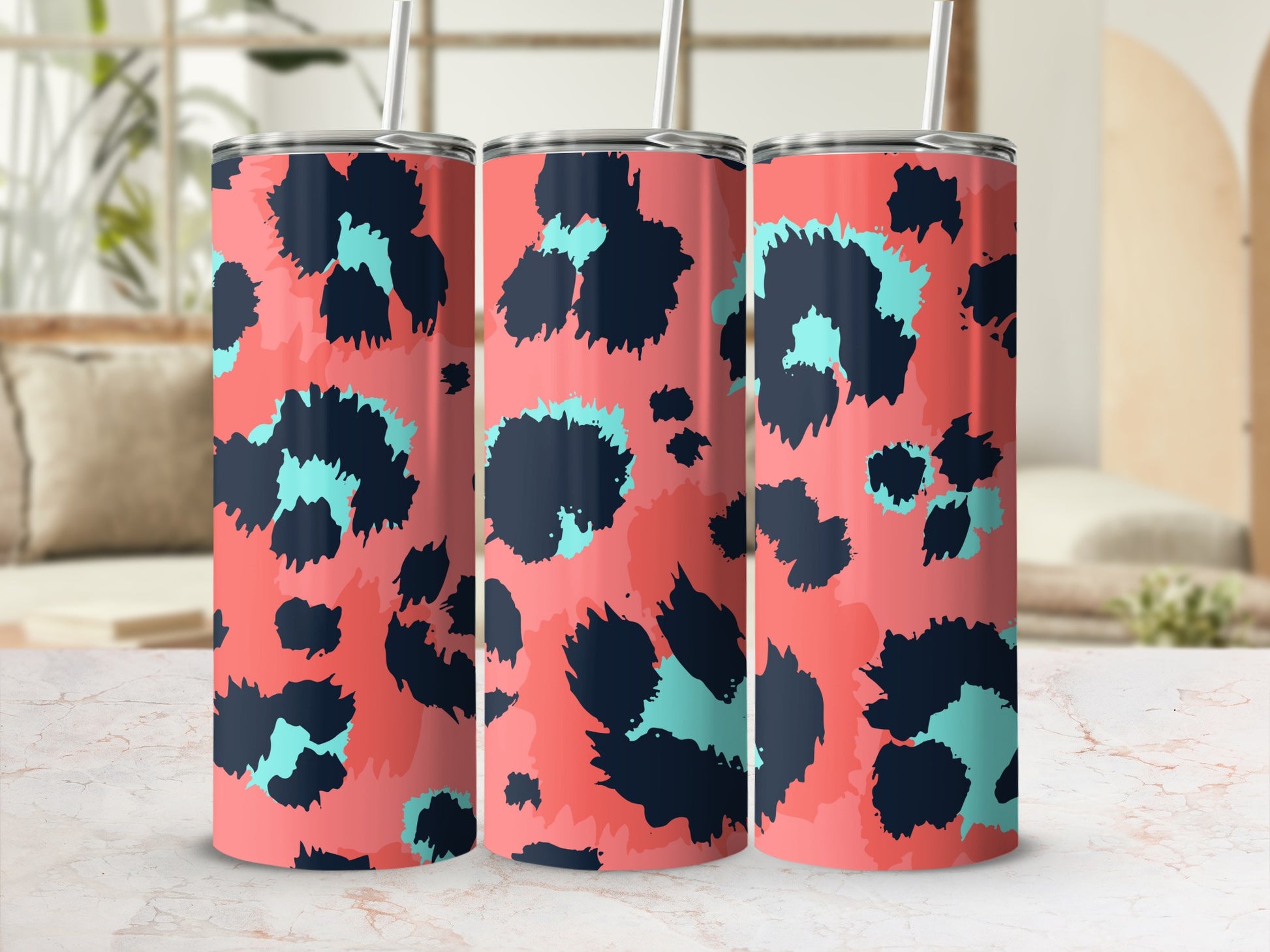 Three tumblers with a coral background and black and turquoise abstract leopard print.
